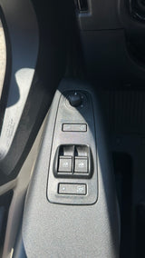 RV rental driver's door: Controls include side mirror adjustment knob, mirror fold, four power window buttons, and child safety lock.