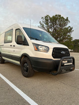 White Ford Transit adventure van with off-road tires and bull bar. Ideal for your next RV rental and exploring Texas.