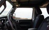 SUV interior: steering wheel, seats (RC logo), person in side mirror. Outside, a landscape. Great vehicle for your RV rental adventures.
