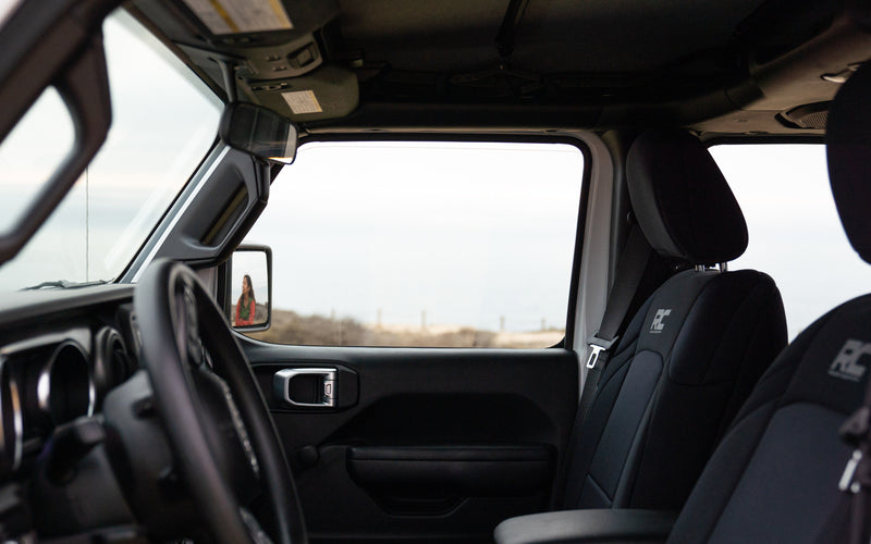 SUV interior: steering wheel, seats (RC logo), person in side mirror. Outside, a landscape. Great vehicle for your RV rental adventures. — photo 8