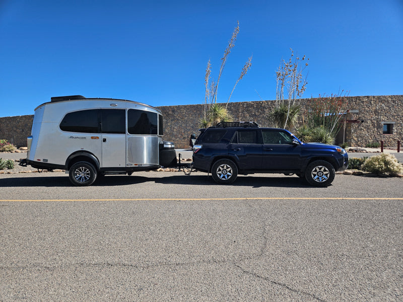 Dark blue SUV towing a sleek Airstream travel trailer. Perfect for an RV rental, camping, or your next road trip adventure! — photo 11