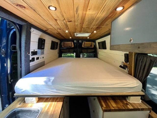  showing a gas strut and ceiling fan.|RV rental's compact kitchen: wooden countertop with sink — photo 16