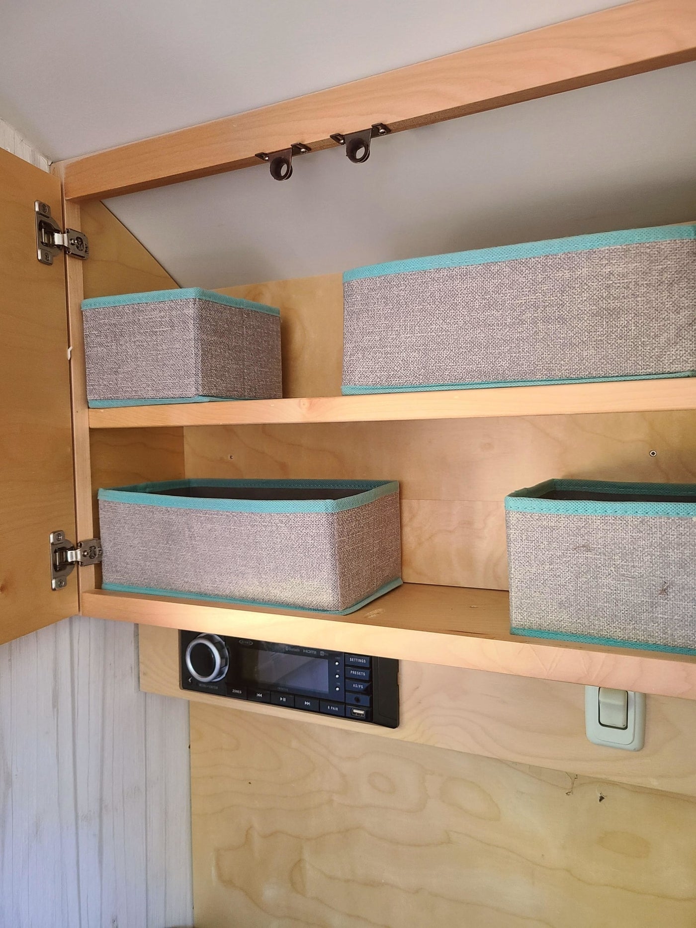  and windows showcasing a serene forest view.|Cozy RV rental interior with decorative bunting — photo 3
