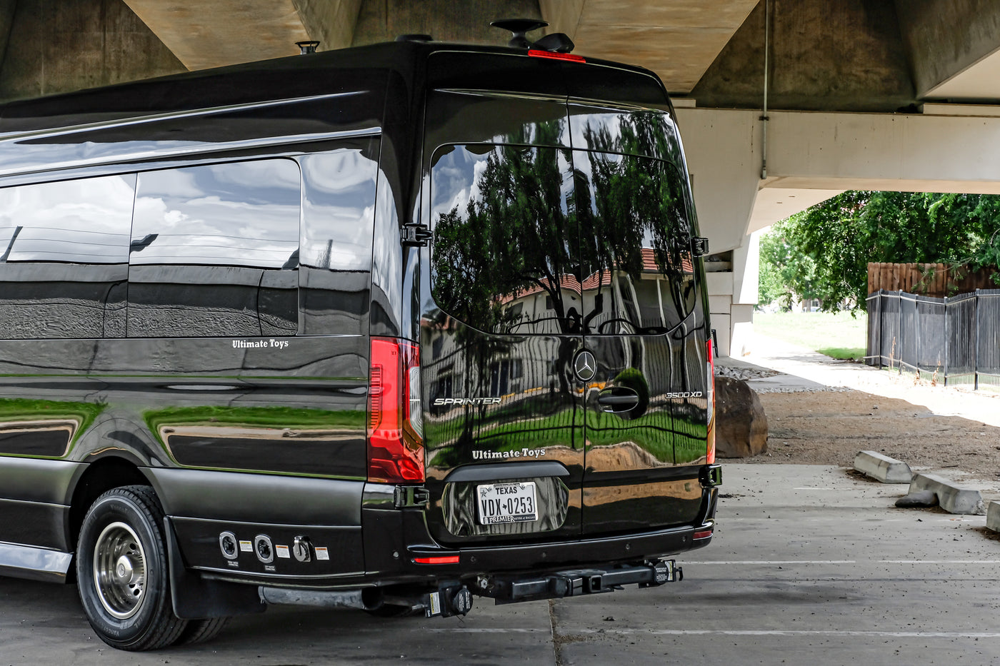 Black Mercedes-Benz Sprinter luxury van, branded Ultimate Toys, perfect for RV rental adventures or executive travel. — photo 16