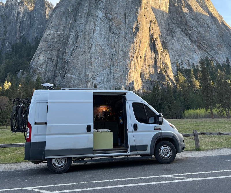 RV rental van parked in a stunning mountain landscape. Bikes on back, Starlink on top. Cozy interior visible, perfect for outdoor adventure. — photo 2