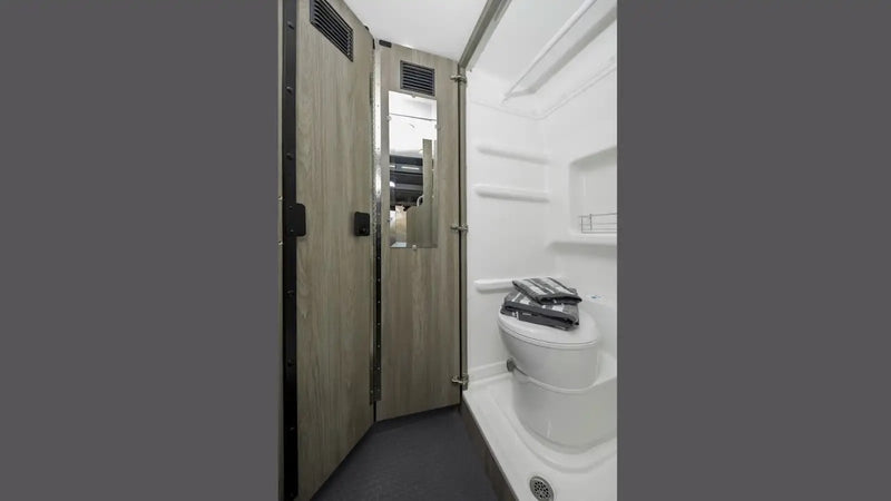  parked in a foggy forest setting.|This RV rental floor plan shows a compact camper van interior layout with a Murphy bed — photo 13