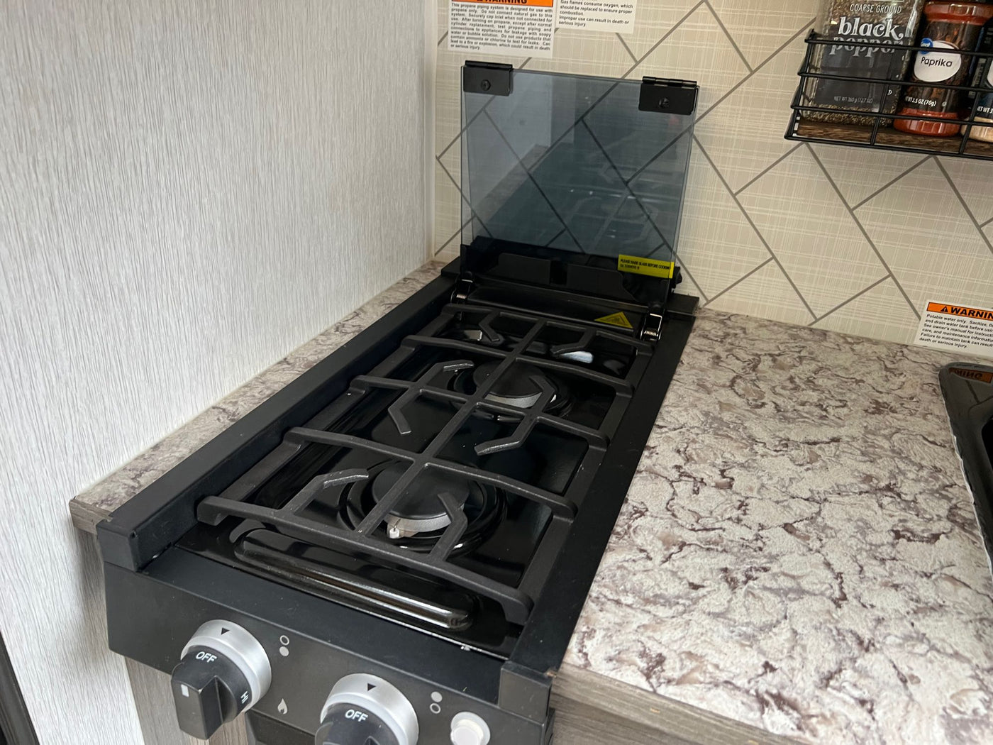  and a cozy bunk bed setup.|RV rental: Compact toilet integrated into the camper's interior for efficient travel & camping.|Close-up of an RV rental's black external shower compartment with a key lock — photo 3