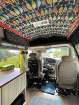  and bright window view.|An RV rental van by a serene river