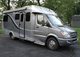 Grey Leisure Travel Unity RV rental on Mercedes-Benz Sprinter chassis, featuring a side awning & stylish decals.