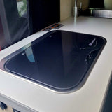 Your RV rental features a clean kitchen with a glass Suburban cooktop and stainless sink.