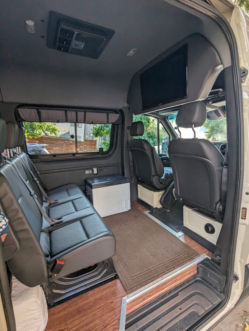  and power outlets for your journey.|Spacious rv rental interior showing passenger seating — photo 1