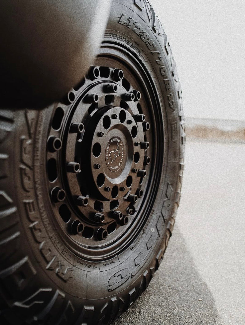 Close-up of a rugged Black Rhino wheel and all-terrain tire (LT 285/70 R17), ideal for your RV rental adventure. — photo 4