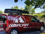 Maroon 'nature vans' van with a Thule roof box, ideal for RV rental adventures.