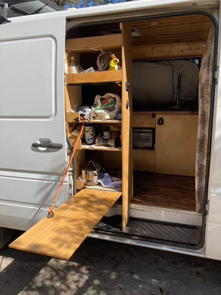 showing the interior. Ready for adventure!|This **RV rental** features a cozy sleeping area with plaid bedding — photo 4