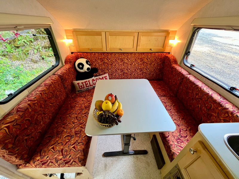  and an outdoor view.|Inside a comfortable rv rental: a well-lit dinette — photo 7