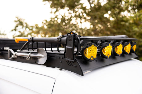 Equipped rv rental: Roof rack displaying off-road shovels and powerful yellow LED adventure lights.