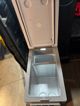 Open portable fridge for an RV rental, showing empty chilled compartments with an interior light. Ready for your travel drinks!