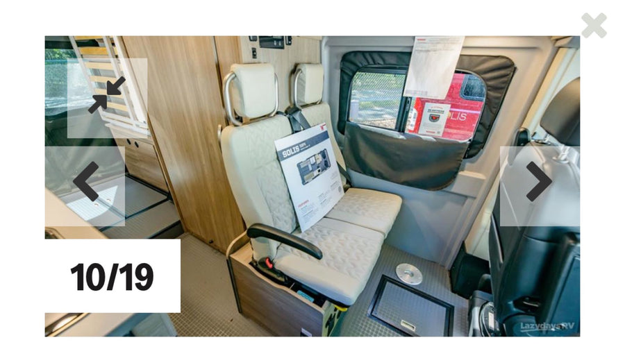  parked in an RV rental lot. Other RVs visible nearby.|RV rental interior: A compact camper van featuring adaptable bench seating and a bed frame. Perfect for trips!|Explore this RV rental's interior: compact kitchen