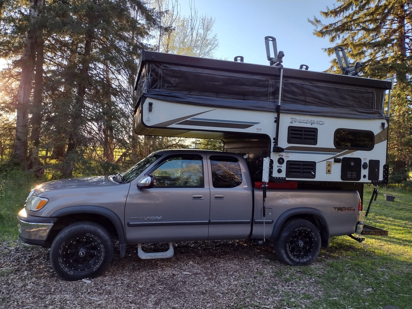 Grey Toyota Tundra truck with a Palomino pop-top truck camper, ideal for an RV rental and off-road camping trips.