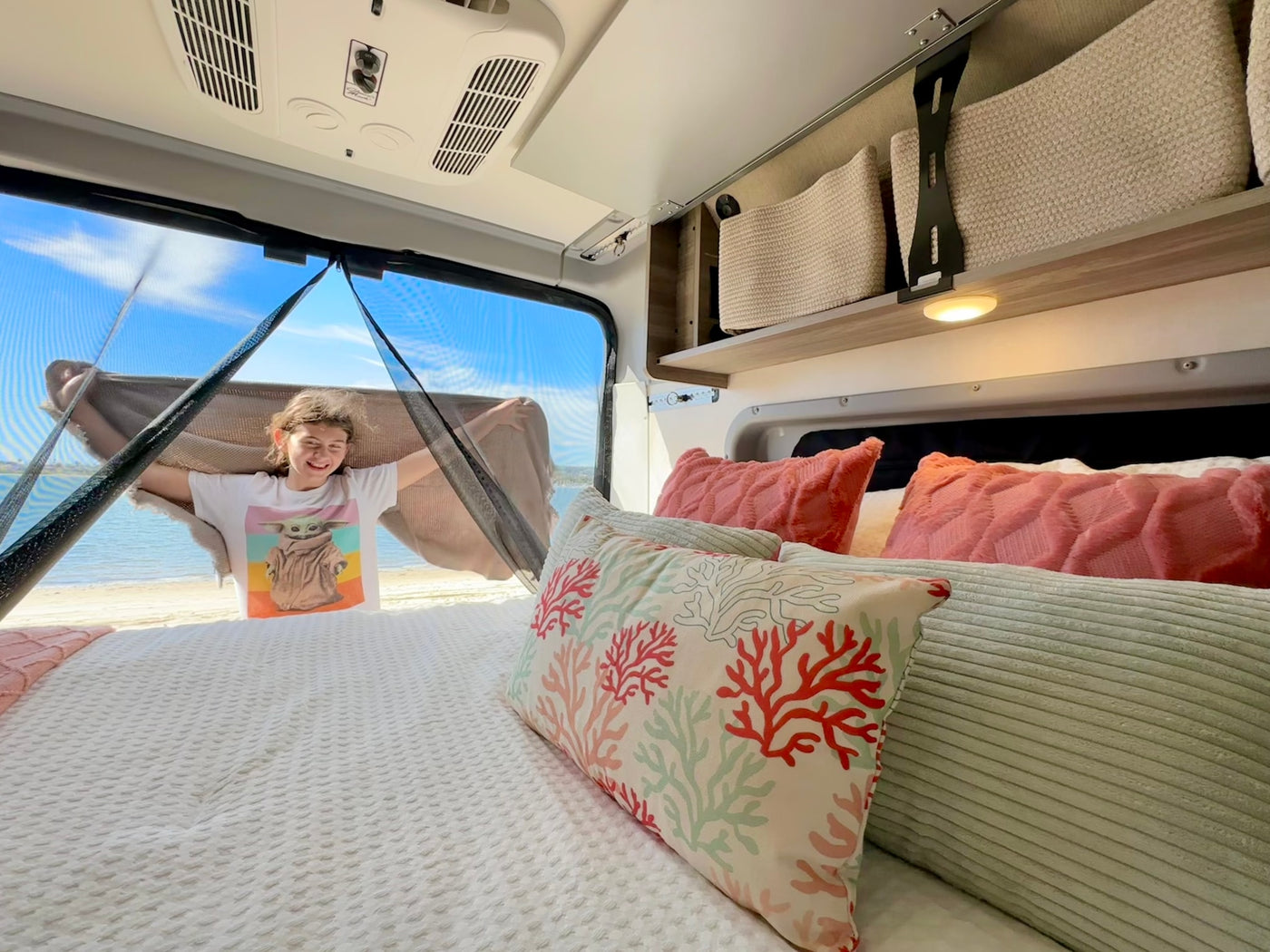  and clever storage.|Inside an RV rental pop-up camper: a cozy bed with "Explore" pillow — photo 10