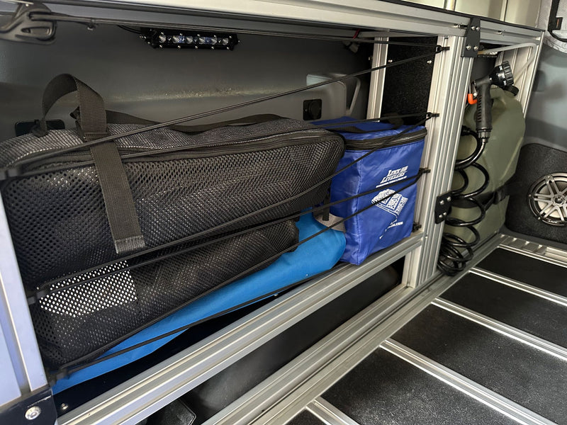  and modular storage system.|Explore this modular RV rental camper van interior: elevated bed — photo 7
