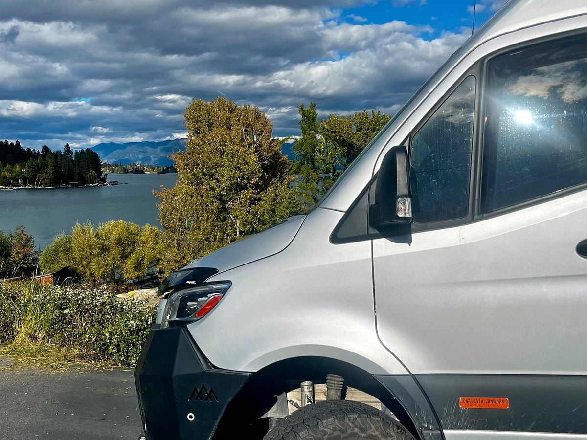  and distant mountains under a bright sun.|RV rental features: Rooftop solar panels provide power. A shovel is stored nearby — photo 13