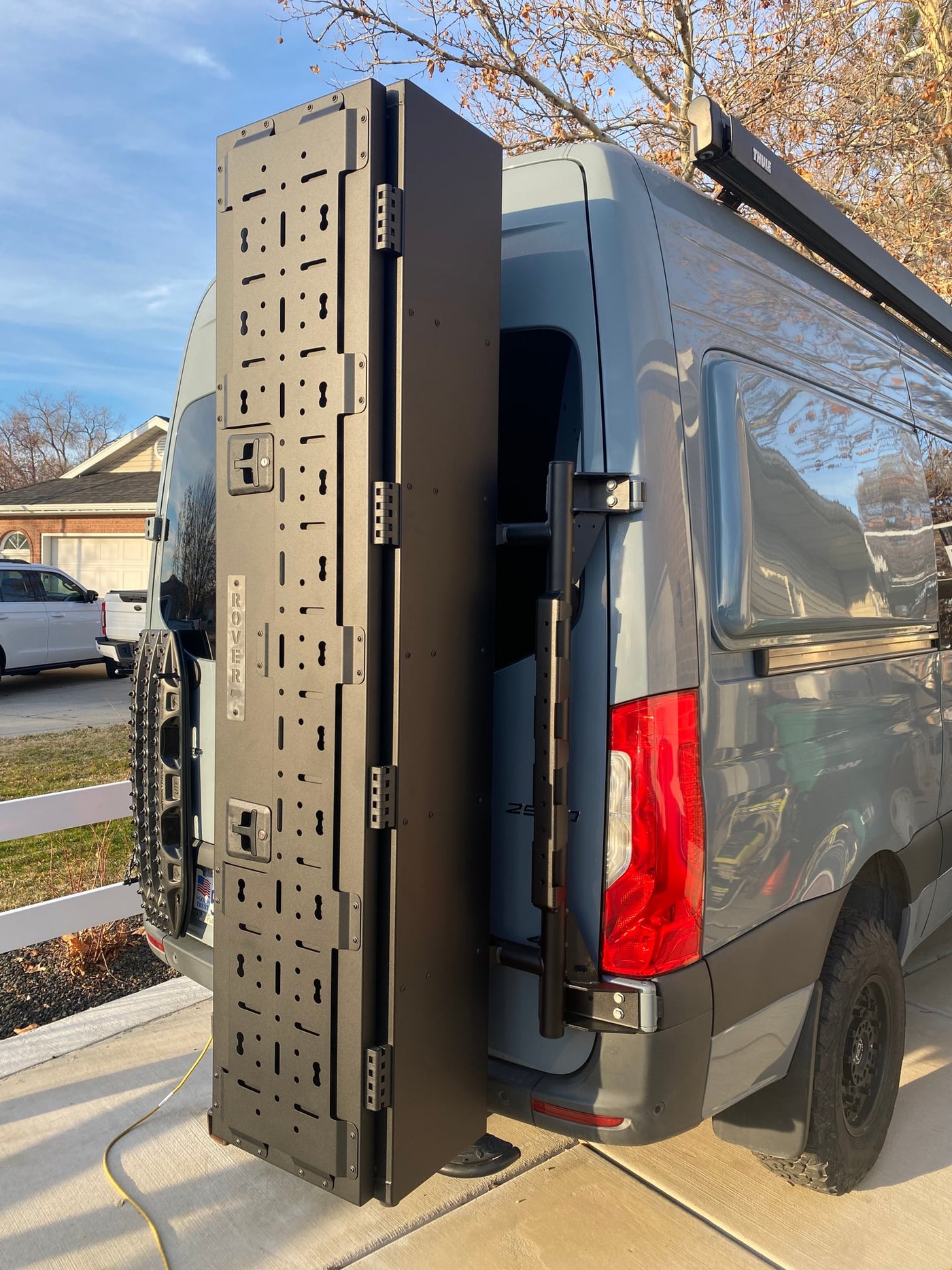 RV rental van's open modular 'ROVER' panel, recovery boards, and Thule awning offer ample gear storage for adventurers. — photo 3