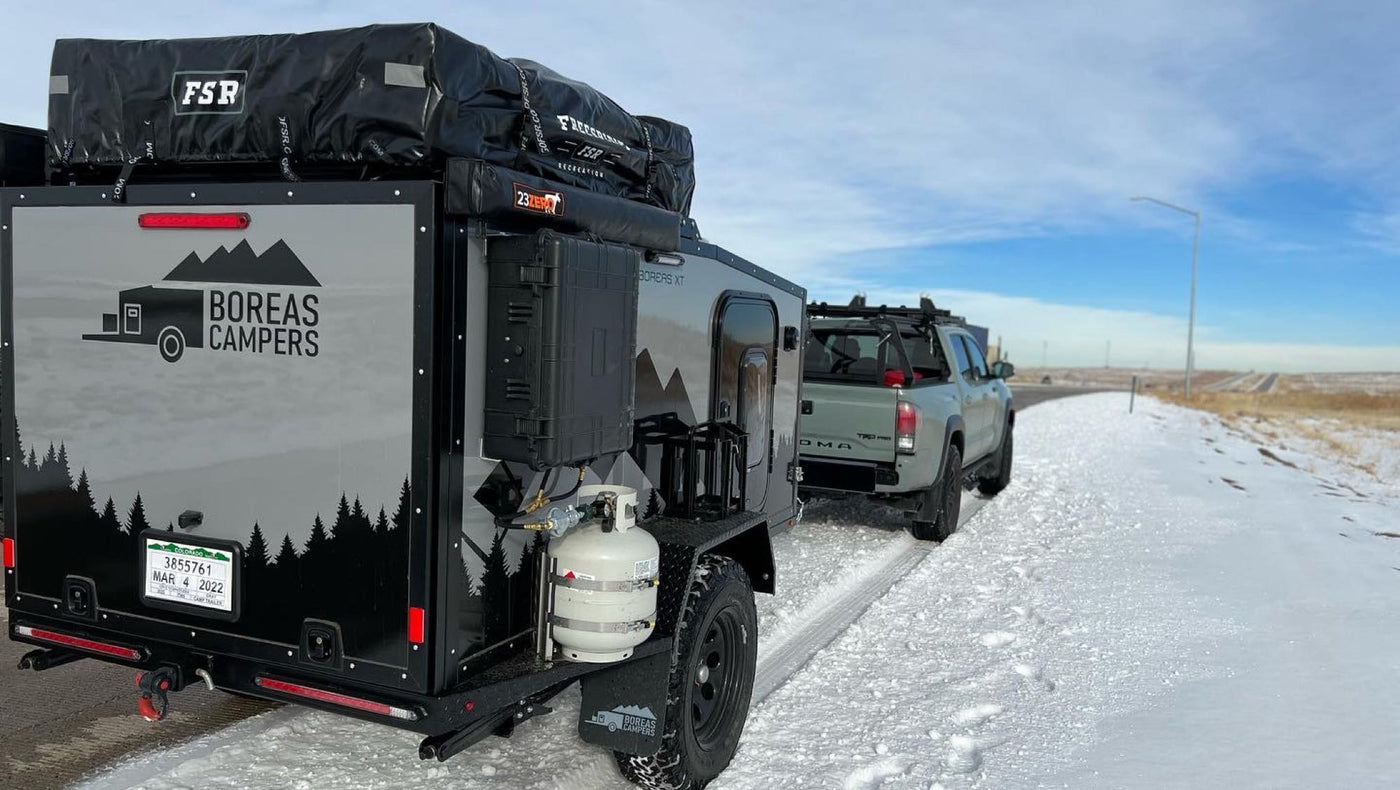  ideal for RV rental adventures! Ready for snow camping with its rooftop tent & rugged build.|Light green Toyota Tacoma towing a compact black & grey off-road trailer — photo 4