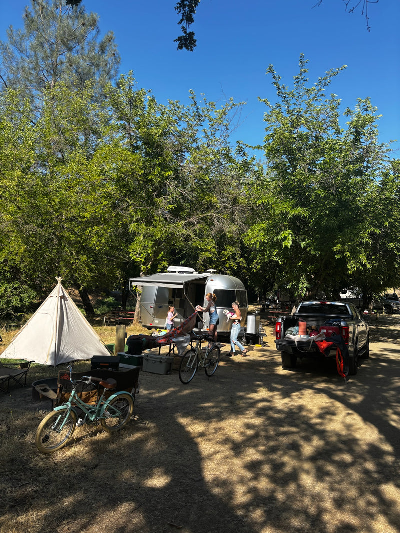  beneath stunning red rock cliffs and a clear blue sky.|Experience nature with this Airstream rv rental! Silver travel trailer nestled at the base of majestic mountains under a bright — photo 2