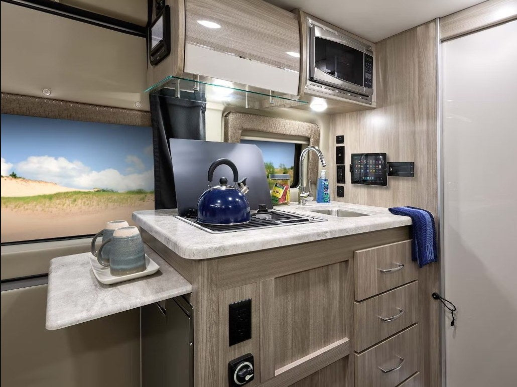  plus swivel front seats.|Experience nature with this black camper van RV rental — photo 8
