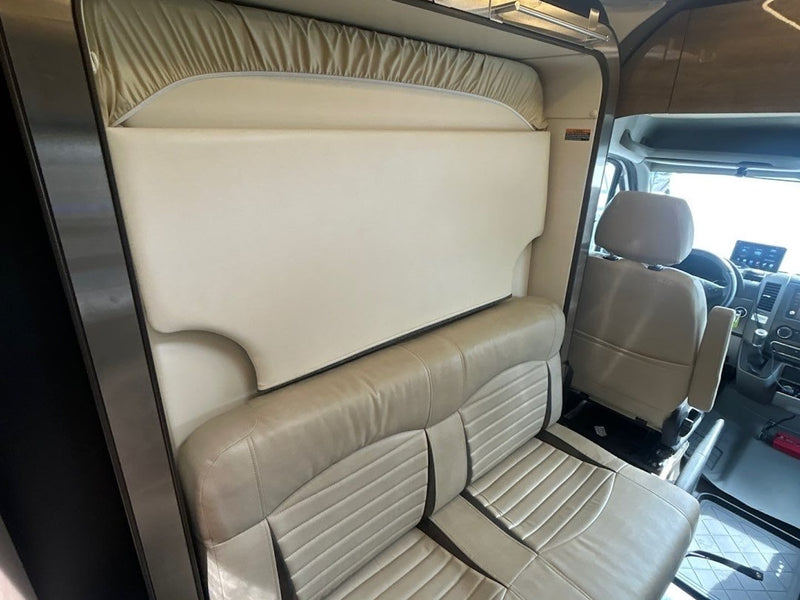  is parked alongside a Forest River Sunseeker van.|Cozy "Carefree RV" blanket on a bed inside an RV rental. Perfect for your next RV adventure or travel getaway.|Explore this RV rental's interior: passenger seat — photo 19