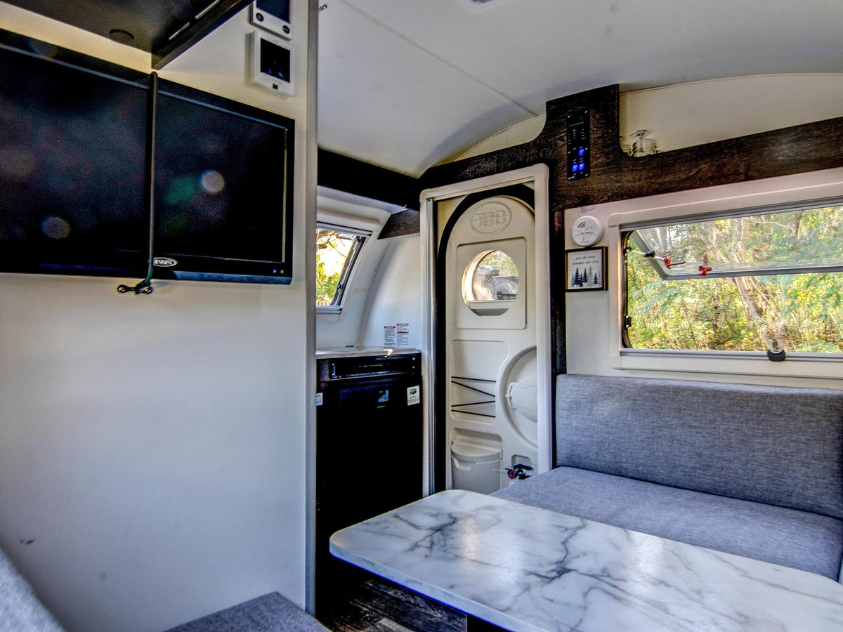  parked by a house amidst mossy trees.|Adventure-ready teardrop RV rental — photo 8