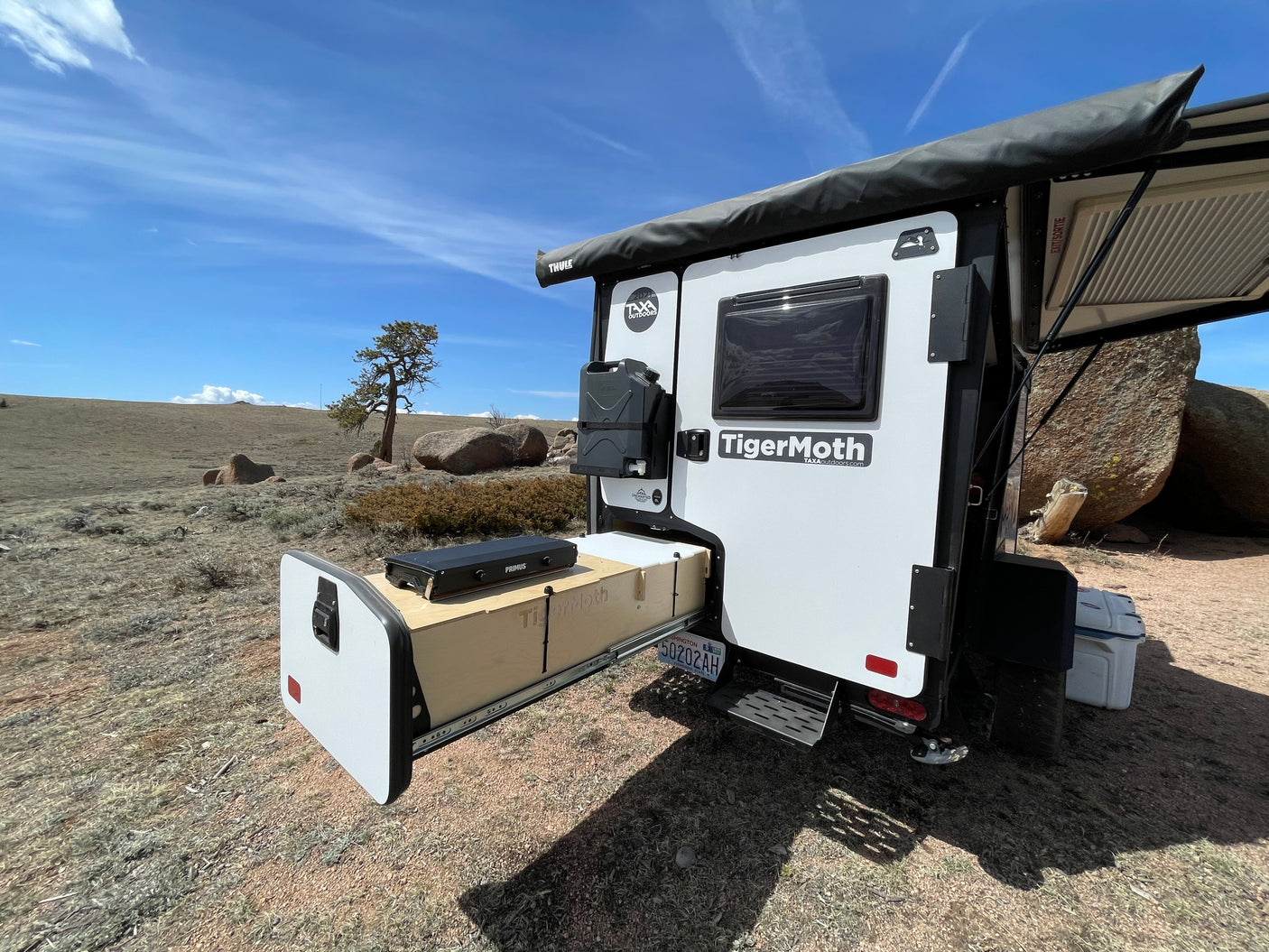 TigerMoth RV rental camping trailer with pull-out kitchen, set up for outdoor adventure.