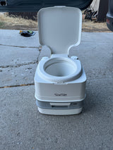This Porta Potti portable toilet is essential for your RV rental adventure, offering comfort and convenience on the go.