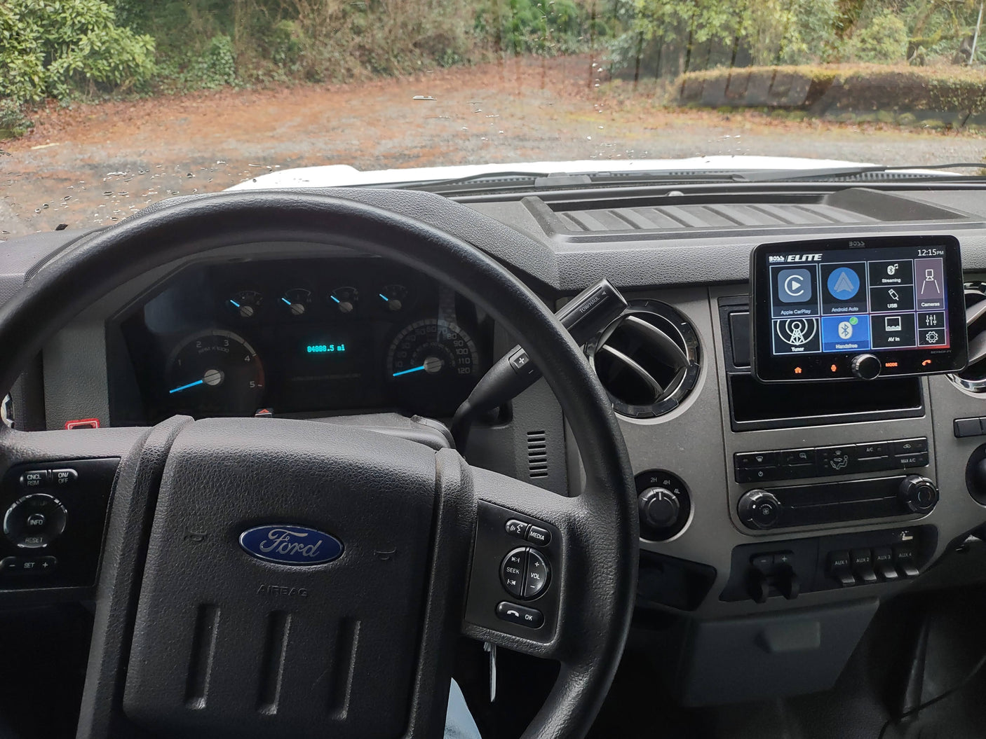 Driver's view in a Ford truck cabin, showing the dashboard with 84888.5 miles, infotainment screen, and controls for an RV rental trip.