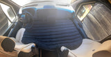 RV rental van interior showing a black air mattress, creating a cozy sleeping setup with sunshades.