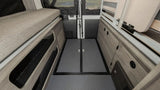 This RV rental's camper van interior showcases a cozy sleeping area, ample storage, and rear doors, ideal for road trips.