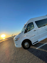 Stunning white Galleria RV rental at sunset. Enjoy road trips, exploring, and scenic views by the water!