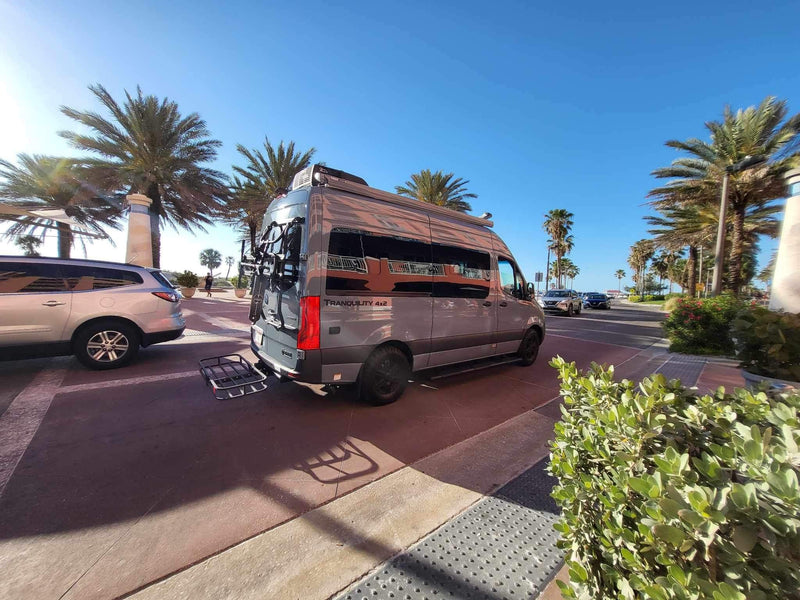 Gray Mercedes Sprinter camper van RV rental with bike rack parked under sunny palm trees. Ideal for a coastal trip. — photo 2