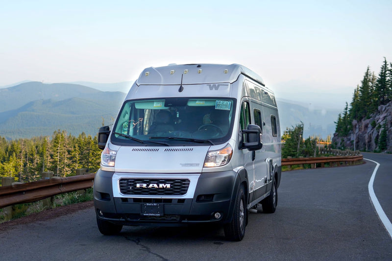  and scenic window view. Perfect mobile office for adventures.|This RV rental's cozy interior offers a comfortable bed — photo 10