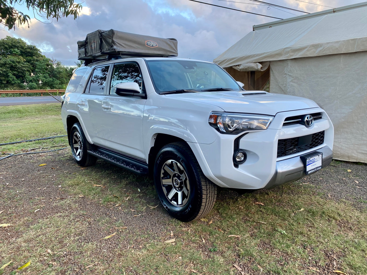 White Toyota 4Runner SUV with a Tepui rooftop tent, an ideal RV rental for off-road camping adventures.