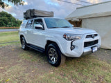 White Toyota 4Runner SUV with a Tepui rooftop tent, an ideal RV rental for off-road camping adventures.