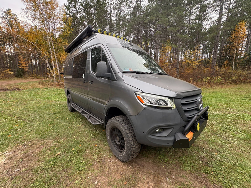  surrounded by autumn trees on a dirt path.|Gray Storyteller adventure van — photo 6