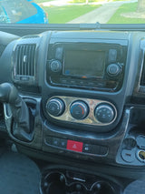 Inside an RV rental: detailed view of the modern dashboard & center console with screen, climate, and driving controls.