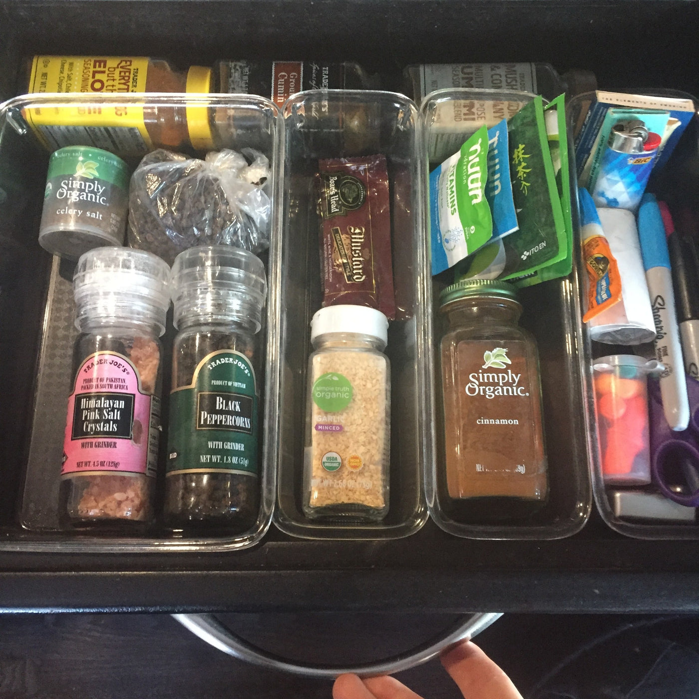 A highly organized RV rental kitchen drawer with various spices, condiments, and small tools, showing efficient storage. — photo 6