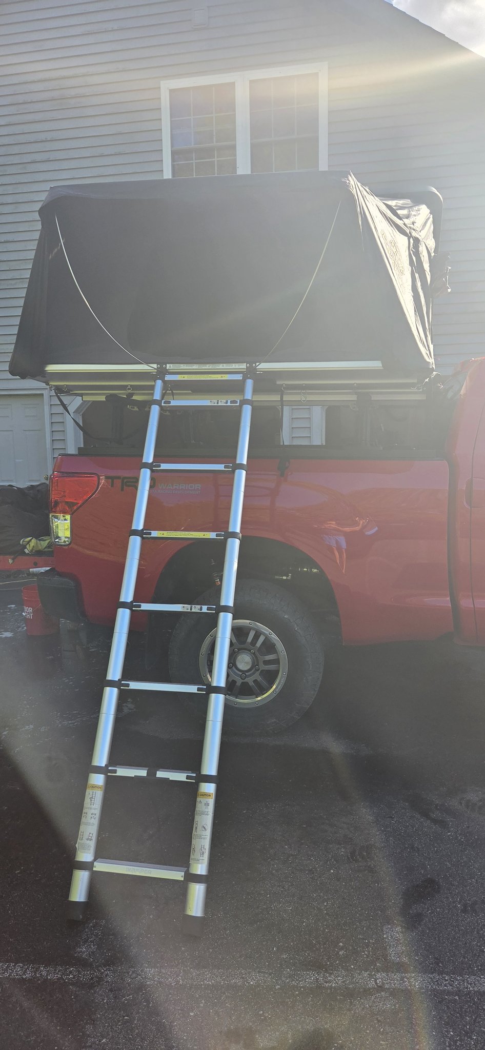Skycamp 3.0 closed on the bed rack with the telescoping ladder extended to the ground — photo 4
