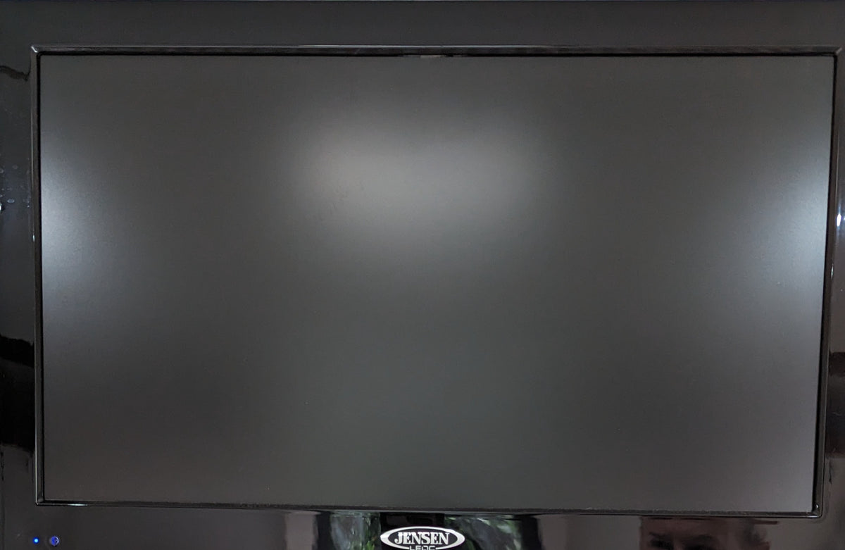 Dark Jensen TV screen inside an RV rental. Features a blue power light & black bezel, ready for your mobile adventures. — photo 9