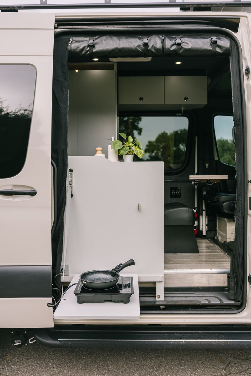  and cozy seating.|Adventure awaits with this tan Truevan 4x4 camper van. Equipped with off-road tires and roof rack — photo 12