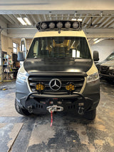 Custom Sprinter adventure van, ready for RV rental. Equipped with prominent off-road lights and a winch bumper.