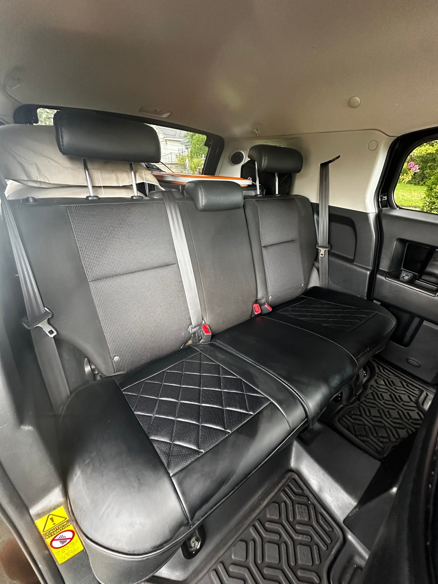 Spacious rear seats with quilted leather in this RV rental. A comfortable car interior, ready for travel adventures. — photo 10